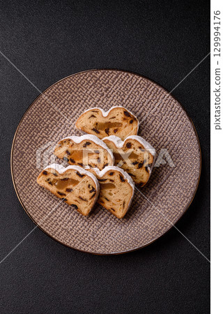 Christmas Stollen, a German sweet cake with marzipan and fruit. Winter Christmas Stollen 129994176