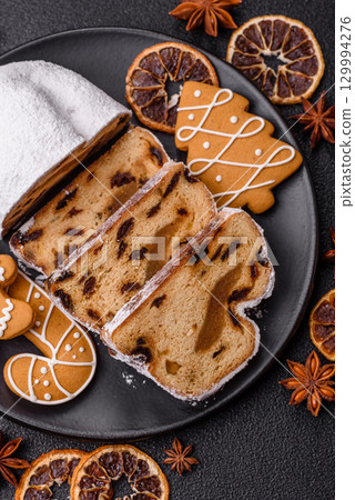 Christmas Stollen, a German sweet cake with marzipan and fruit. Winter Christmas Stollen 129994276