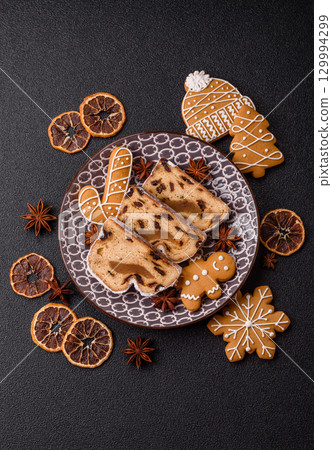 Christmas Stollen, a German sweet cake with marzipan and fruit. Winter Christmas Stollen Christmas Stollen, a German sweet cake with marzipan and fruit. Winter Christmas Stollen 129994299