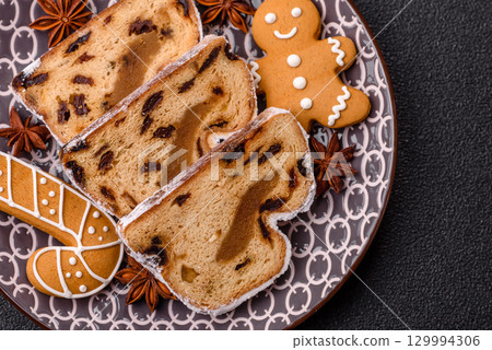 Christmas Stollen, a German sweet cake with marzipan and fruit. Winter Christmas Stollen Christmas Stollen, a German sweet cake with marzipan and fruit. Winter Christmas Stollen 129994306