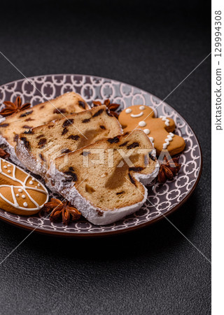 Christmas Stollen, a German sweet cake with marzipan and fruit. Winter Christmas Stollen Christmas Stollen, a German sweet cake with marzipan and fruit. Winter Christmas Stollen 129994308