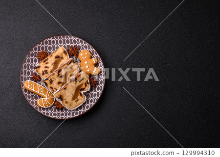 Christmas Stollen, a German sweet cake with marzipan and fruit. Winter Christmas Stollen 129994310