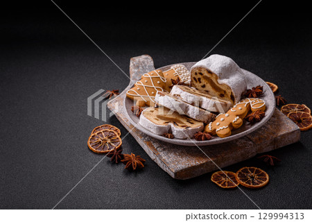 Christmas Stollen, a German sweet cake with marzipan and fruit. Winter Christmas Stollen Christmas Stollen, a German sweet cake with marzipan and fruit. Winter Christmas Stollen 129994313