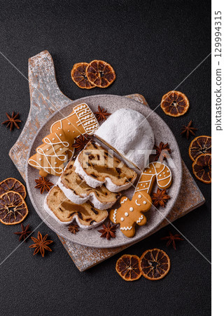 Christmas Stollen, a German sweet cake with marzipan and fruit. Winter Christmas Stollen Christmas Stollen, a German sweet cake with marzipan and fruit. Winter Christmas Stollen 129994315