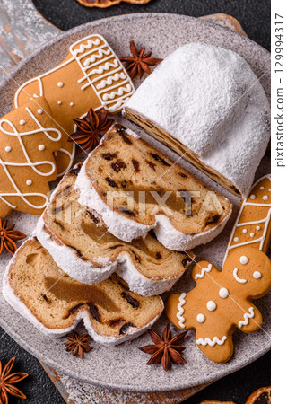 Christmas Stollen, a German sweet cake with marzipan and fruit. Winter Christmas Stollen Christmas Stollen, a German sweet cake with marzipan and fruit. Winter Christmas Stollen 129994317