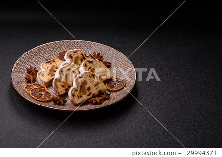 Christmas Stollen, a German sweet cake with marzipan and fruit. Winter Christmas Stollen Christmas Stollen, a German sweet cake with marzipan and fruit. Winter Christmas Stollen 129994371