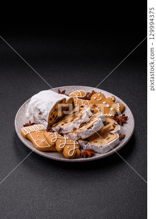 Christmas Stollen, a German sweet cake with marzipan and fruit. Winter Christmas Stollen Christmas Stollen, a German sweet cake with marzipan and fruit. Winter Christmas Stollen 129994375