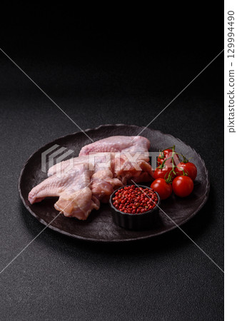 Raw chicken wings, fresh uncooked poultry meat. Chicken or turkey wings 129994490