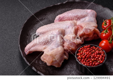 Raw chicken wings, fresh uncooked poultry meat. Chicken or turkey wings Raw chicken wings, fresh uncooked poultry meat. Chicken or turkey wings 129994491