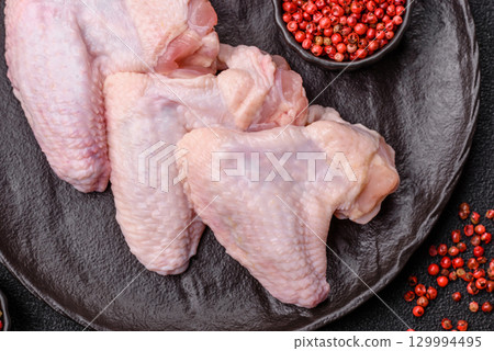 Raw chicken wings, fresh uncooked poultry meat. Chicken or turkey wings Raw chicken wings, fresh uncooked poultry meat. Chicken or turkey wings 129994495