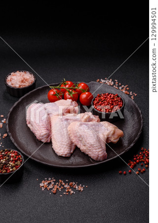 Raw chicken wings, fresh uncooked poultry meat. Chicken or turkey wings 129994501