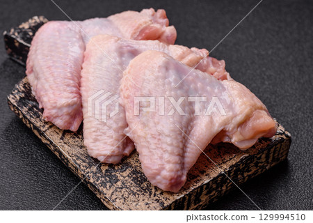 Raw chicken wings, fresh uncooked poultry meat. Chicken or turkey wings 129994510