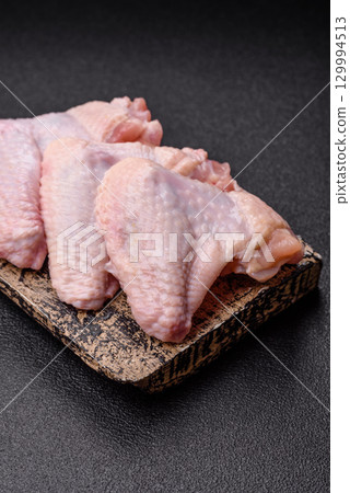 Raw chicken wings, fresh uncooked poultry meat. Chicken or turkey wings 129994513