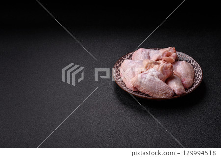 Raw chicken wings, fresh uncooked poultry meat. Chicken or turkey wings 129994518