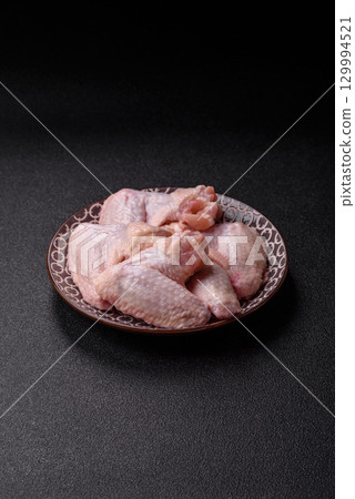 Raw chicken wings, fresh uncooked poultry meat. Chicken or turkey wings Raw chicken wings, fresh uncooked poultry meat. Chicken or turkey wings 129994521