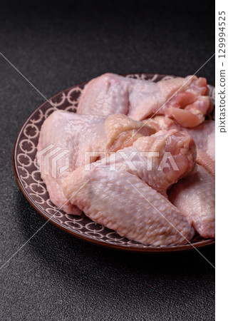 Raw chicken wings, fresh uncooked poultry meat. Chicken or turkey wings 129994525
