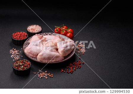 Raw chicken wings, fresh uncooked poultry meat. Chicken or turkey wings Raw chicken wings, fresh uncooked poultry meat. Chicken or turkey wings 129994530
