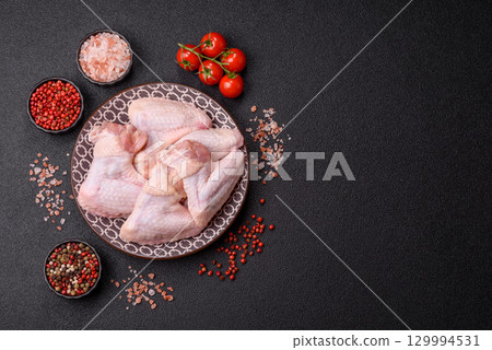 Raw chicken wings, fresh uncooked poultry meat. Chicken or turkey wings Raw chicken wings, fresh uncooked poultry meat. Chicken or turkey wings 129994531