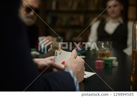 Serious determined man thinking about the course of the poker game in a vintage bar 129994585