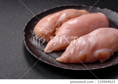 Meat, raw chicken fillets, poultry breast, skinless and boneless food. Raw chicken fillet 129994623