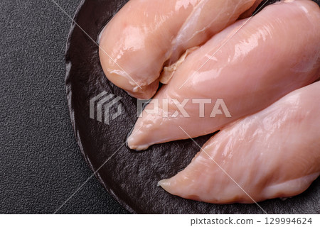 Meat, raw chicken fillets, poultry breast, skinless and boneless food. Raw chicken fillet Meat, raw chicken fillets, poultry breast, skinless and boneless food. Raw chicken fillet 129994624