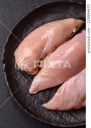 Meat, raw chicken fillets, poultry breast, skinless and boneless food. Raw chicken fillet 129994625