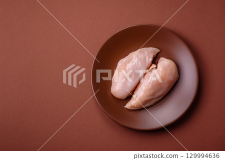 Meat, raw chicken fillets, poultry breast, skinless and boneless food. Raw chicken fillet Meat, raw chicken fillets, poultry breast, skinless and boneless food. Raw chicken fillet 129994636