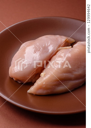 Meat, raw chicken fillets, poultry breast, skinless and boneless food. Raw chicken fillet Meat, raw chicken fillets, poultry breast, skinless and boneless food. Raw chicken fillet 129994642