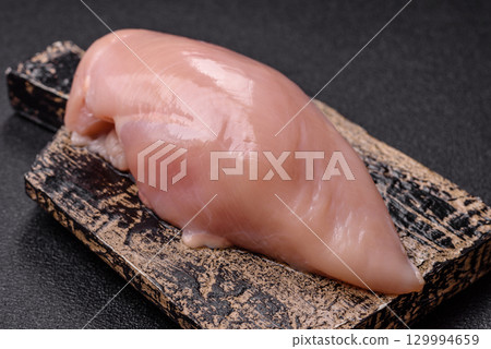 Meat, raw chicken fillets, poultry breast, skinless and boneless food. Raw chicken fillet 129994659