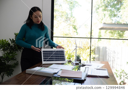A sales representative presenting solar and wind power, alternative energy, clean energy  129994846