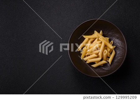Penne pasta cooked with cheese, salt and spices. Italian food penne pasta 129995209