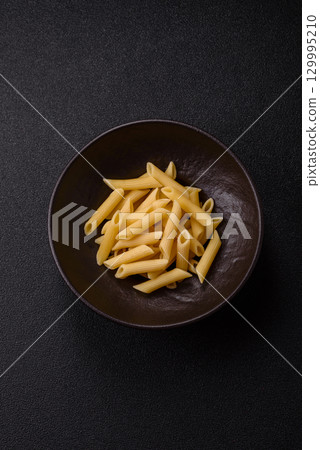 Penne pasta cooked with cheese, salt and spices. Italian food penne pasta Penne pasta cooked with cheese, salt and spices. Italian food penne pasta 129995210
