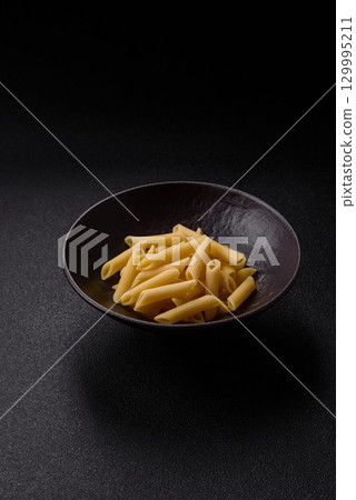 Penne pasta cooked with cheese, salt and spices. Italian food penne pasta Penne pasta cooked with cheese, salt and spices. Italian food penne pasta 129995211