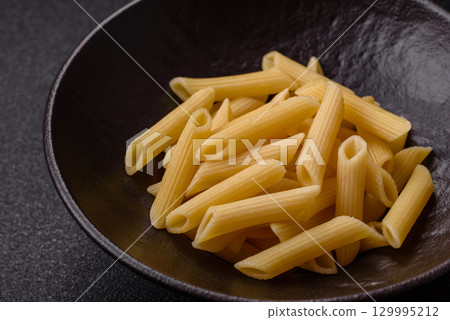 Penne pasta cooked with cheese, salt and spices. Italian food penne pasta 129995212