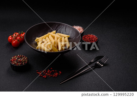 Penne pasta cooked with cheese, salt and spices. Italian food penne pasta 129995220