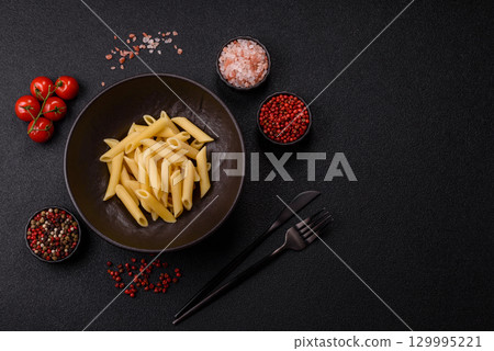 Penne pasta cooked with cheese, salt and spices. Italian food penne pasta 129995221