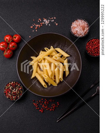 Penne pasta cooked with cheese, salt and spices. Italian food penne pasta 129995222