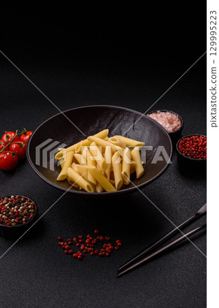 Penne pasta cooked with cheese, salt and spices. Italian food penne pasta 129995223