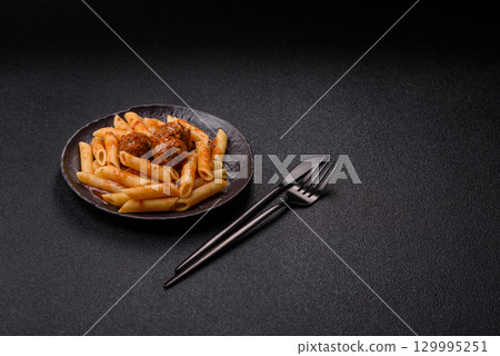 Penne pasta with meatballs in tomato sauce with salt and spices. Italian food penne pasta Penne pasta with meatballs in tomato sauce with salt and spices. Italian food penne pasta 129995251