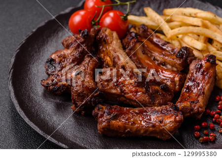 Meat, beef ribs in a marinade grilled with salt and spices. Grilled ribs 129995380