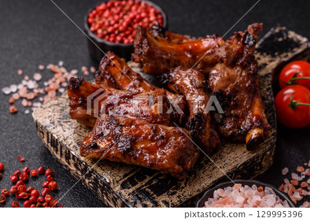 Meat, beef ribs in a marinade grilled with salt and spices. Grilled ribs Meat, beef ribs in a marinade grilled with salt and spices. Grilled ribs 129995396