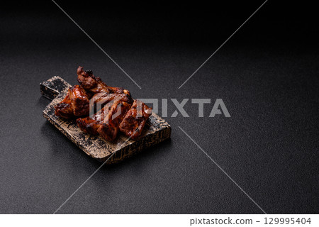 Meat, beef ribs in a marinade grilled with salt and spices. Grilled ribs 129995404