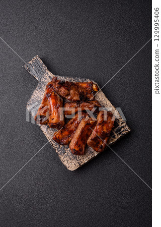 Meat, beef ribs in a marinade grilled with salt and spices. Grilled ribs Meat, beef ribs in a marinade grilled with salt and spices. Grilled ribs 129995406