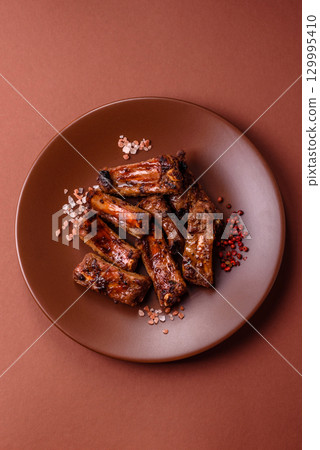Meat, beef ribs in a marinade grilled with salt and spices. Grilled ribs 129995410