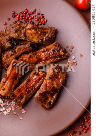 Meat, beef ribs in a marinade grilled with salt and spices. Grilled ribs 129995417