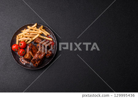 Meat, beef ribs in a marinade grilled with salt and spices. Grilled ribs 129995436
