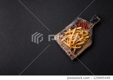 Food, French fries fried with salt and rosemary. Homemade crispy chips 129995440