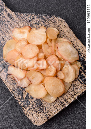 Food, dried squid in shavings or chopped as snacks or jerky. Snack dried squid for beer Food, dried squid in shavings or chopped as snacks or jerky. Snack dried squid for beer 129995531