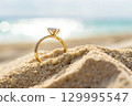 wedding ring on the sand 129995547