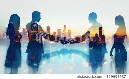 Happy group shaking hands near water with city skyline in background 129995587